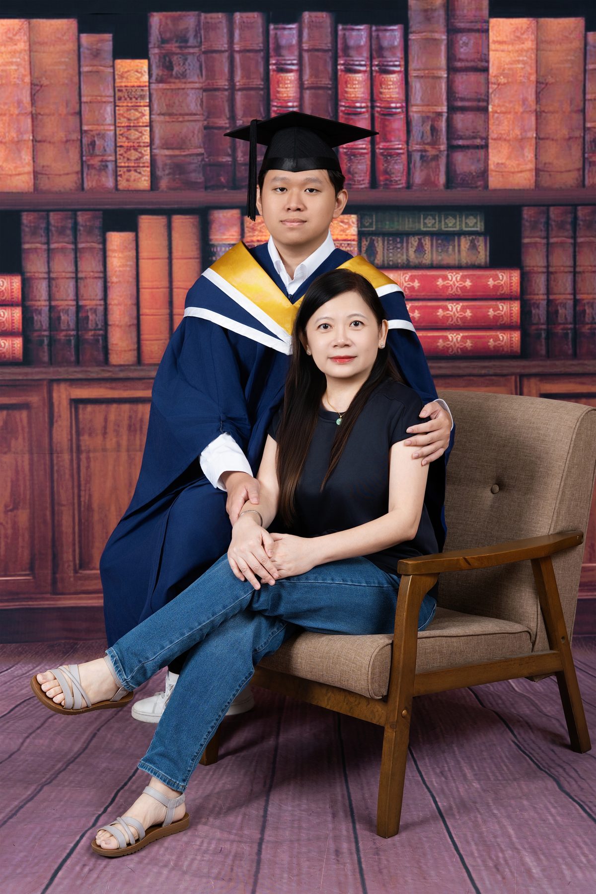 Premo Studio real client graduation photo — graduate with diploma tube, editorial portrait