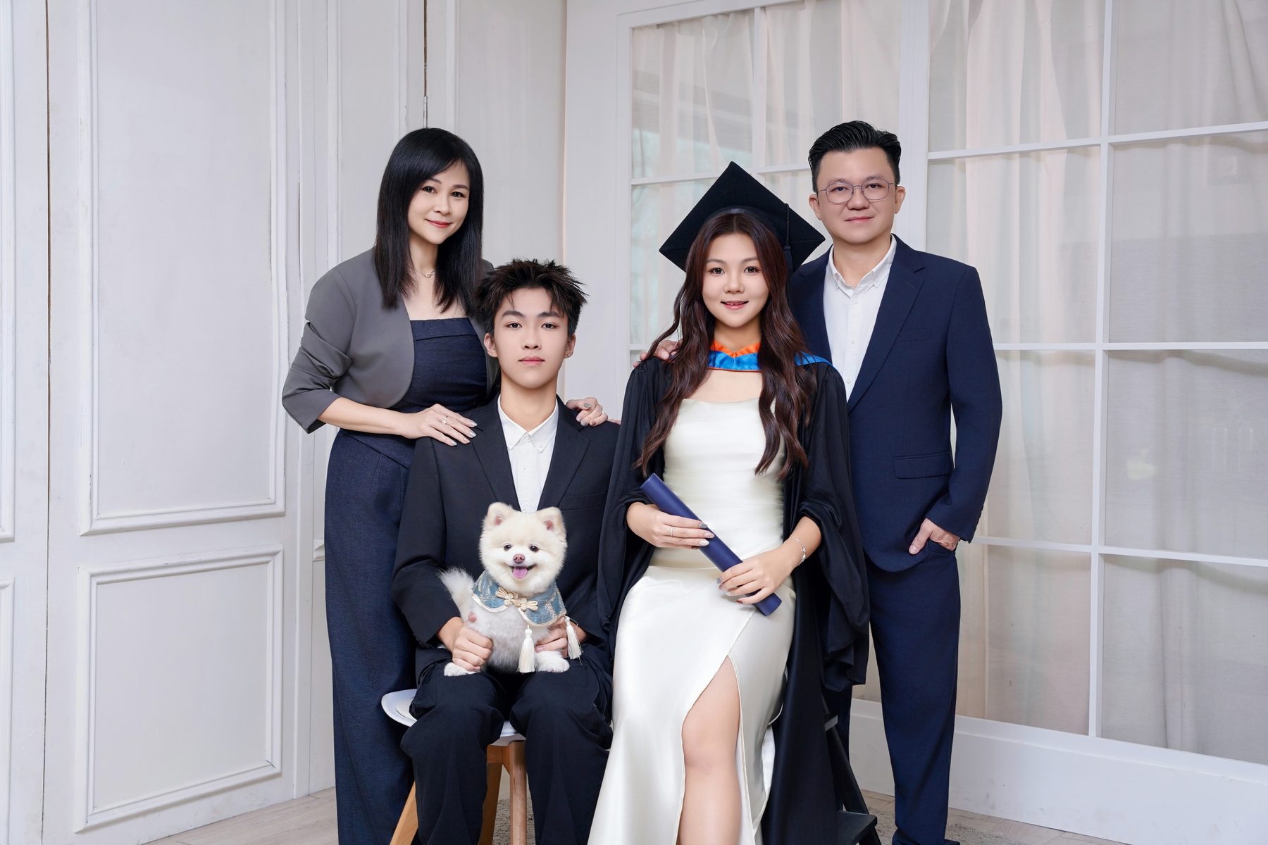 Premo Studio real client graduation photo — family of five with graduate and pet