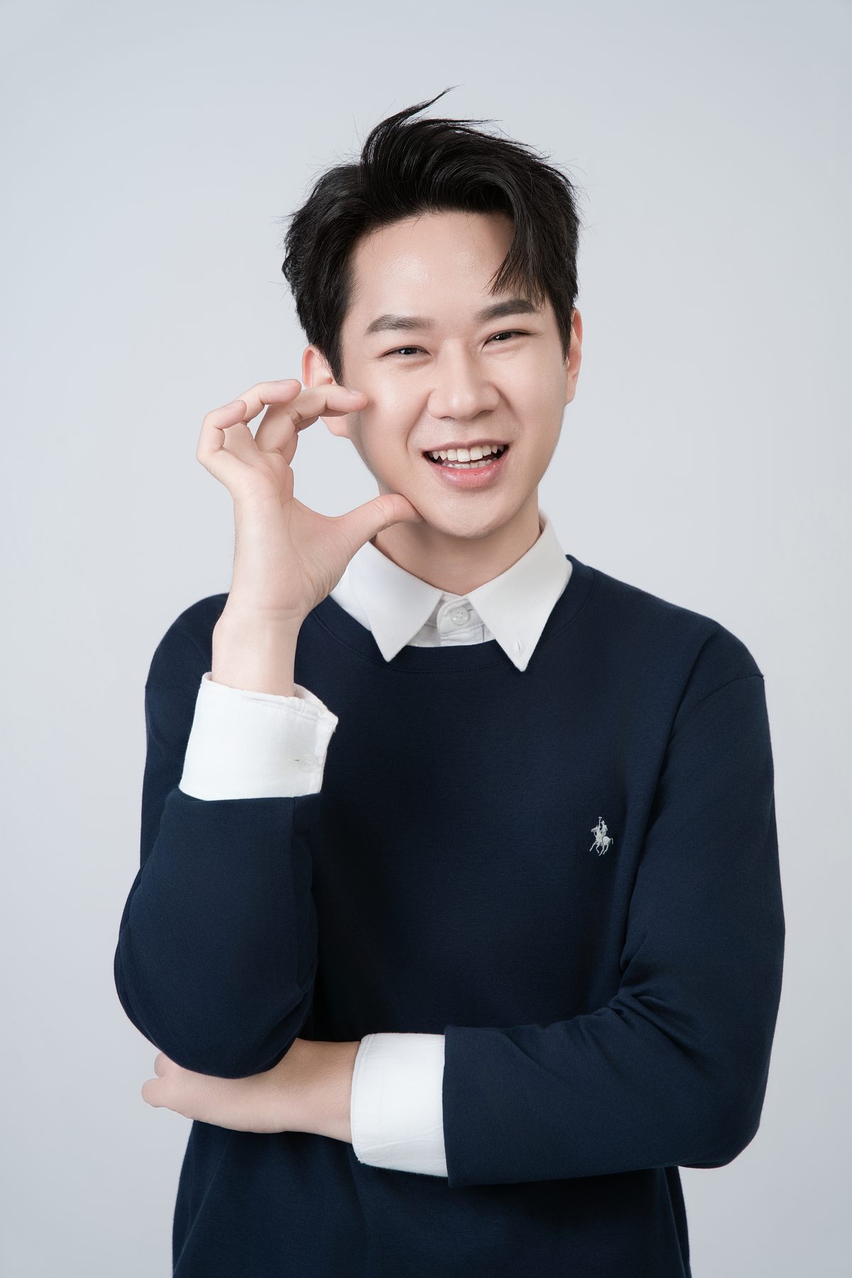 Premo Studio real client business portrait — young man, casual polo shirt