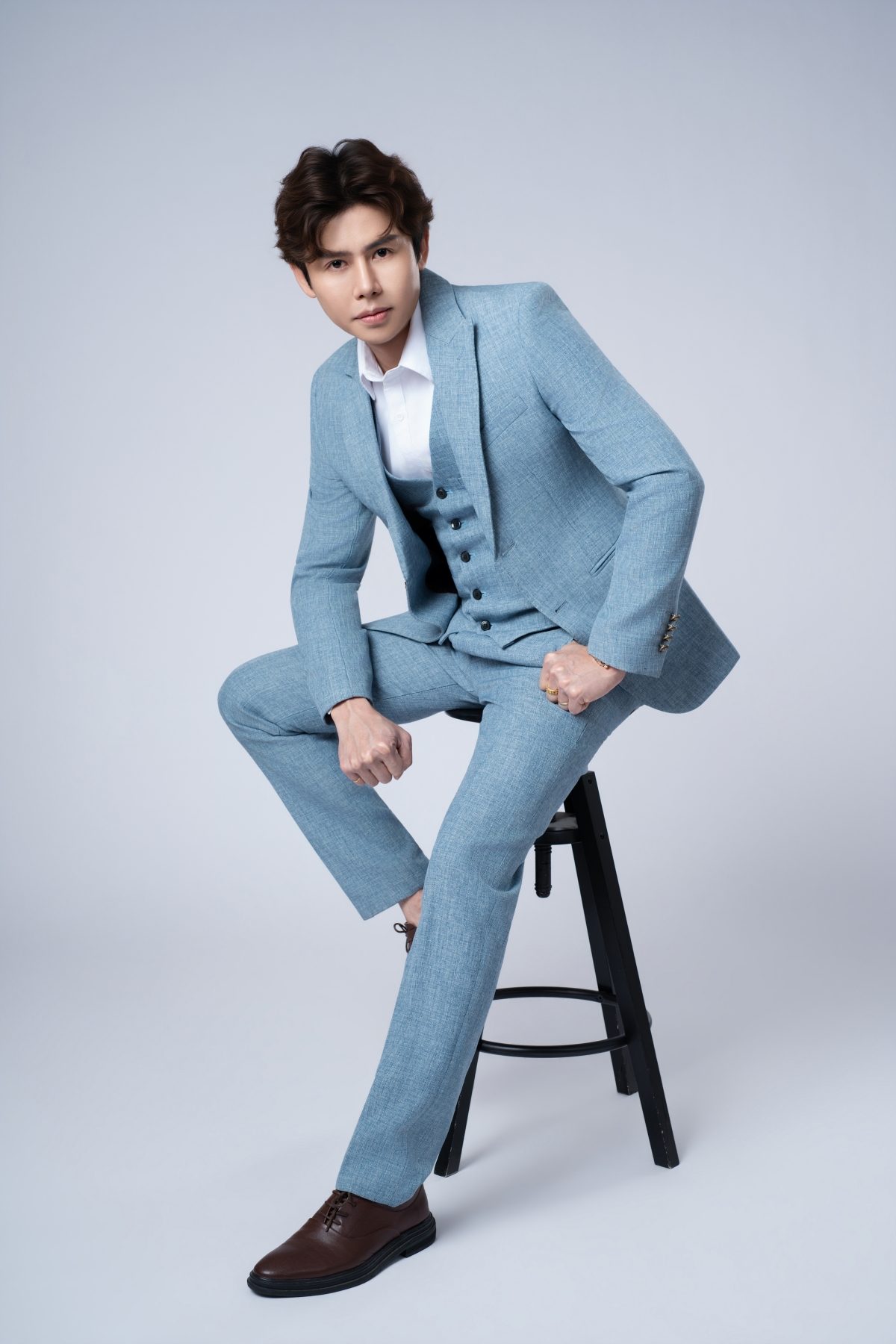 Premo Studio real client business portrait — man in blue suit, editorial style