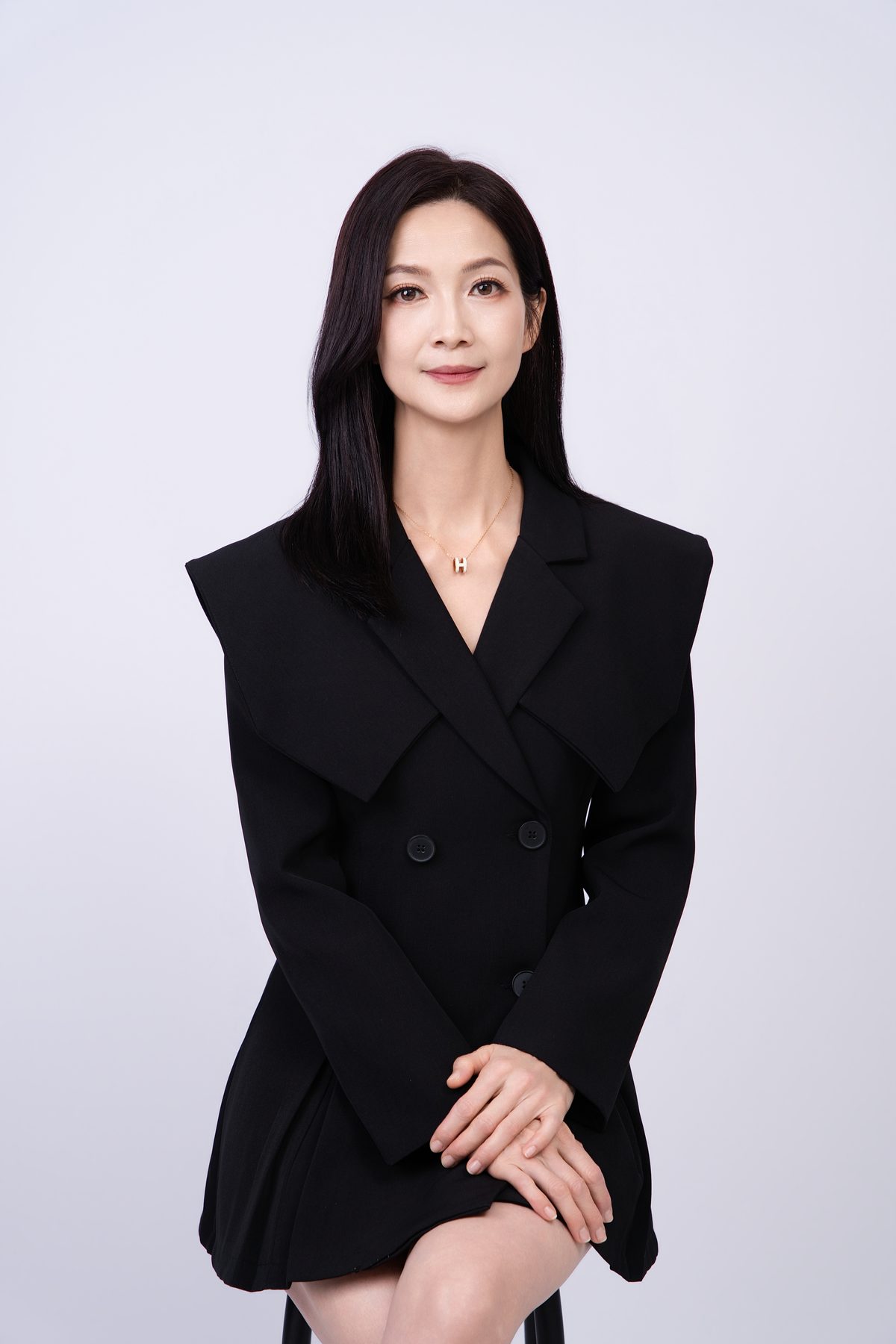 Premo Studio real client business portrait — woman in black blazer, studio portrait