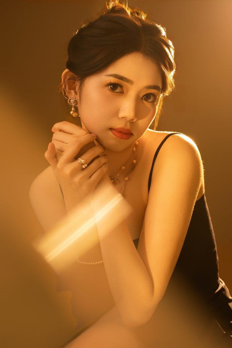 Premo Studio real client business portrait — woman with jewelry, warm lighting