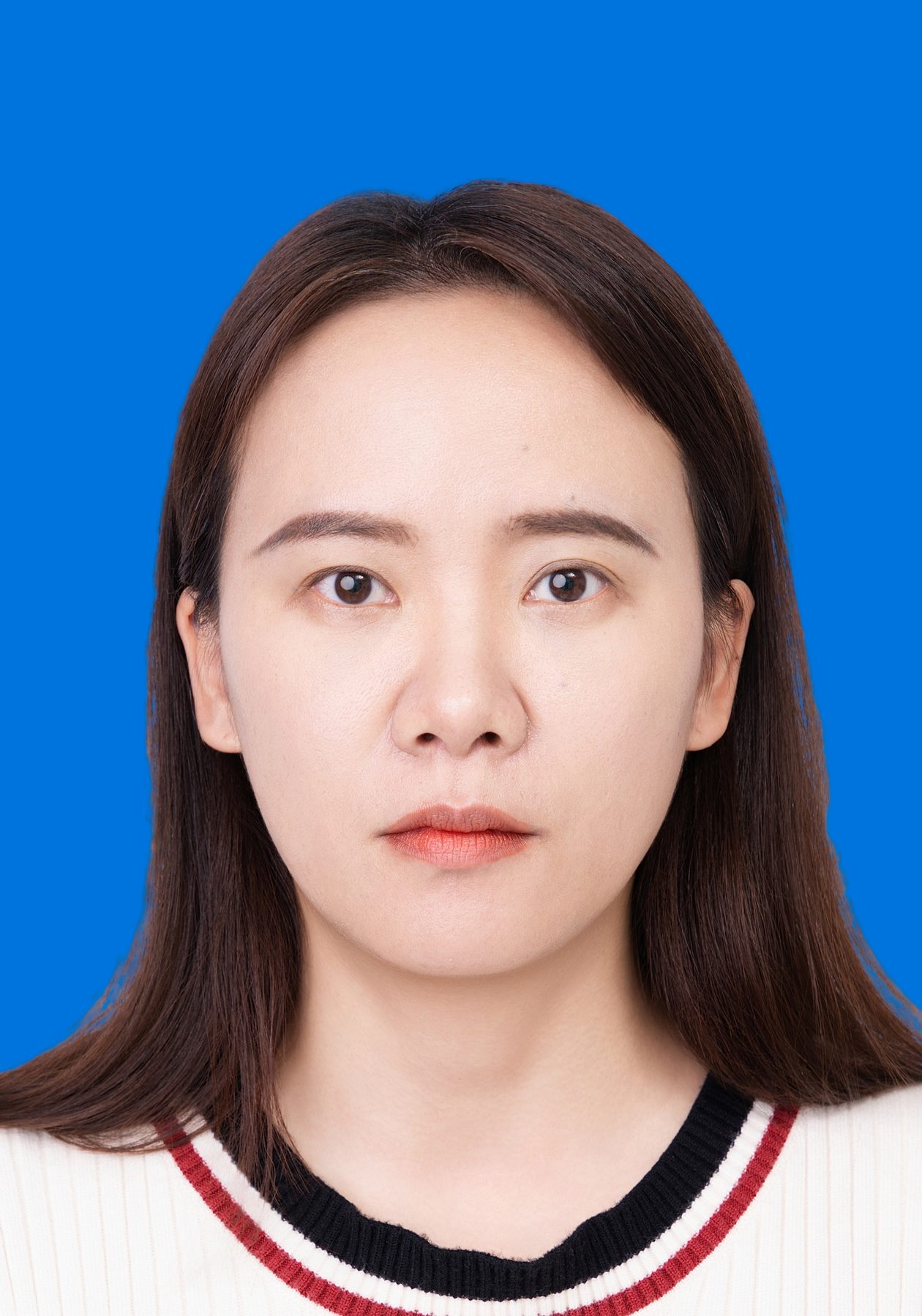 Premo Studio real client passport photo — woman, blue background