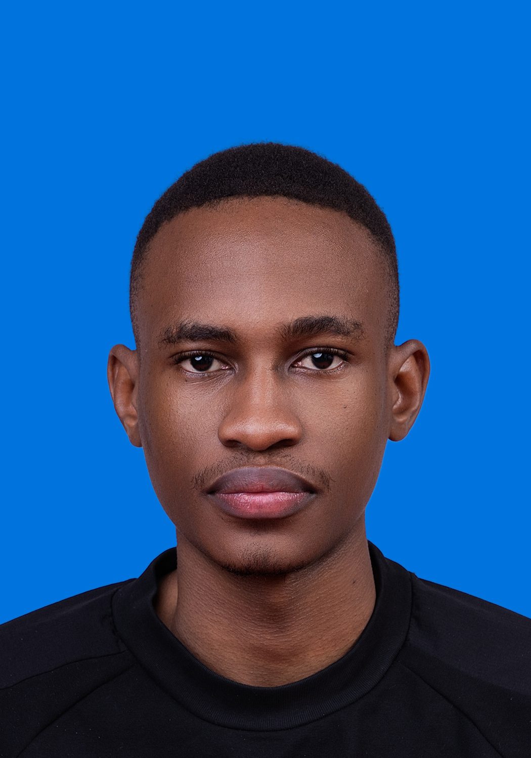 Premo Studio real client passport photo — man, blue background