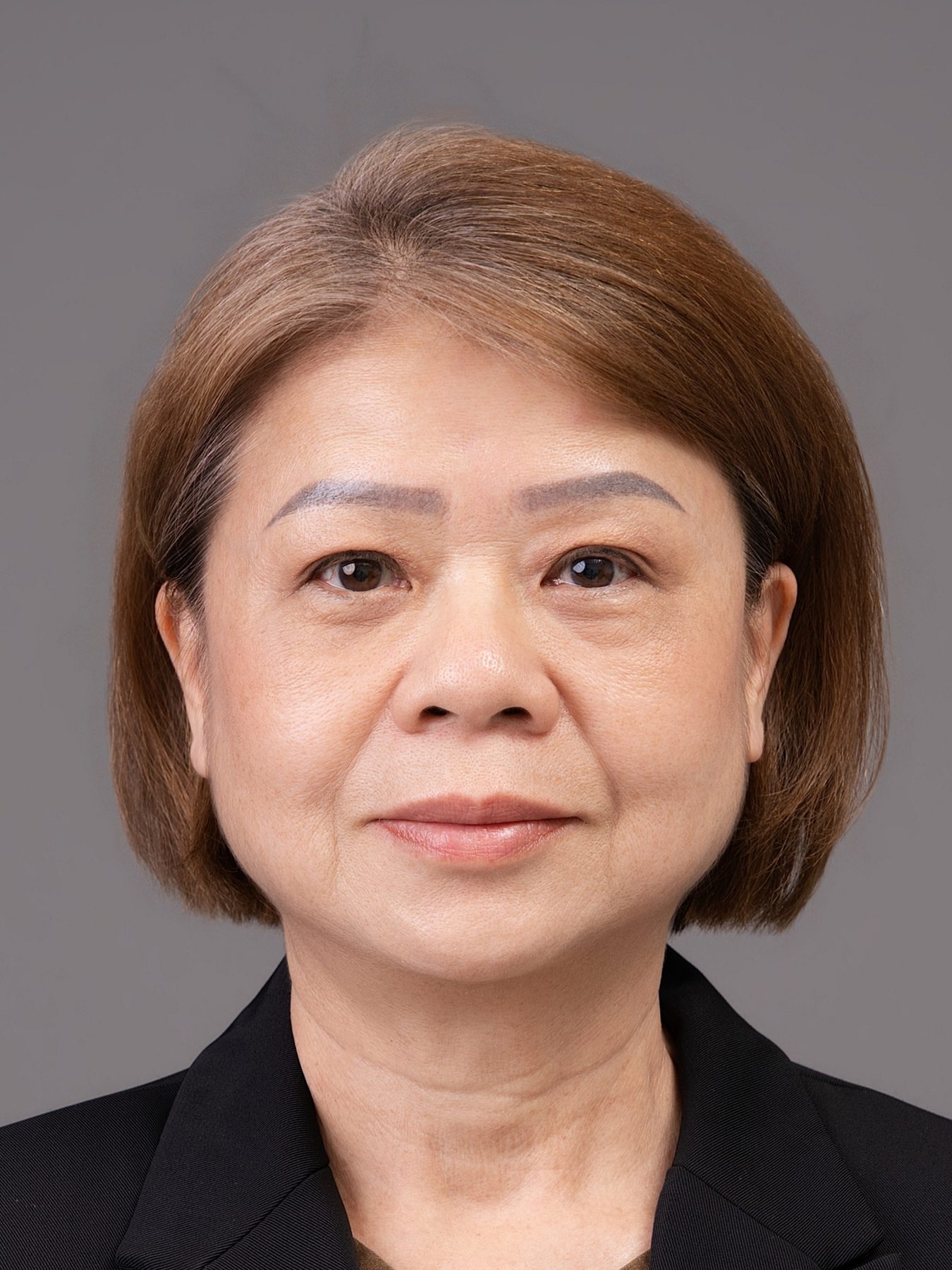 Premo Studio real client passport photo — senior woman, grey background