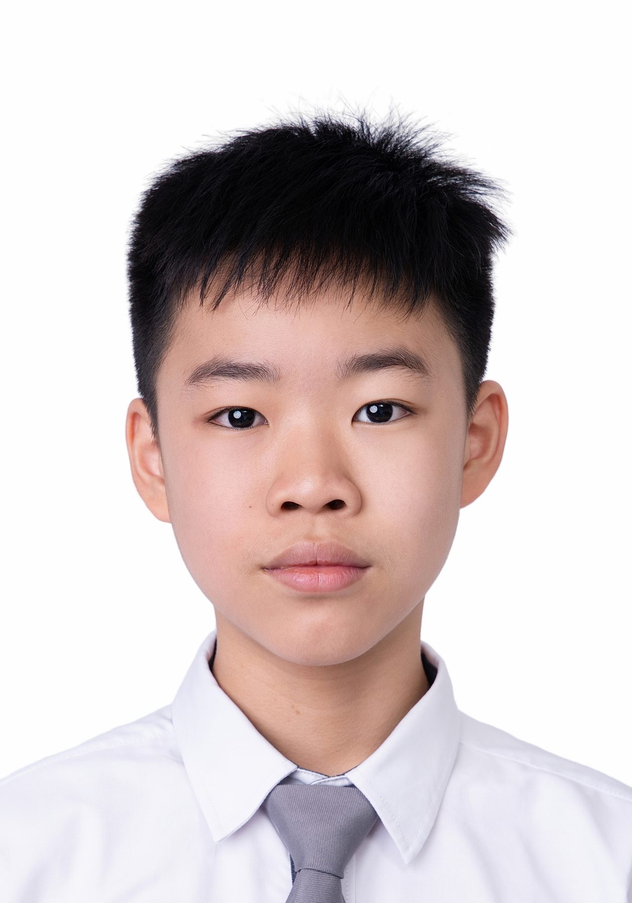Premo Studio real client passport photo — teenage boy, white background